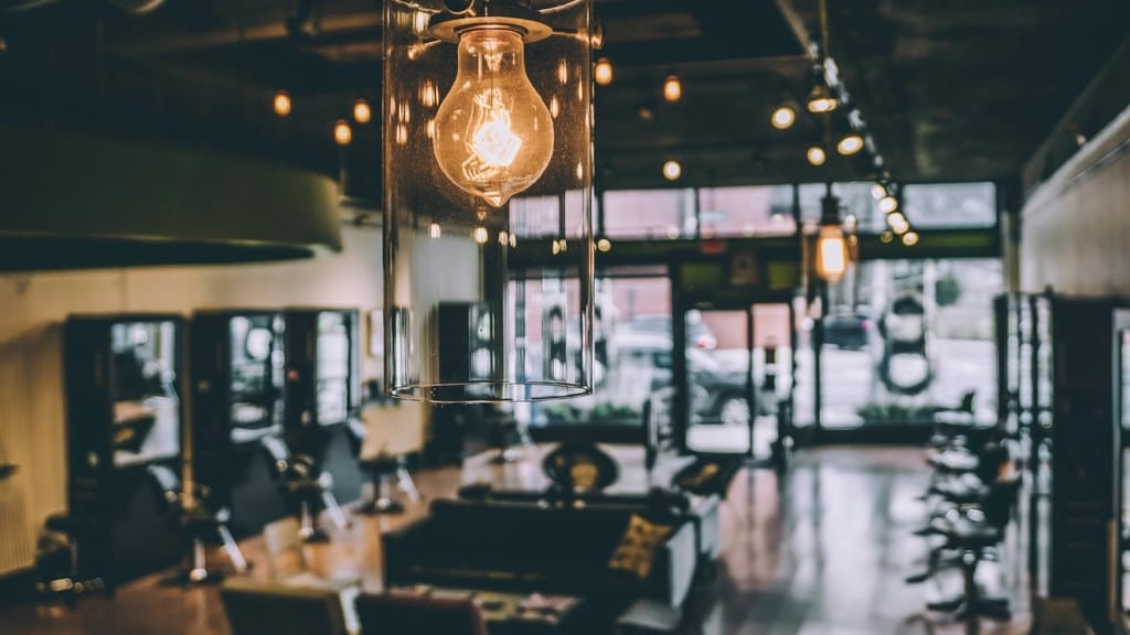 Moody salon interior with warm Edison bulbs